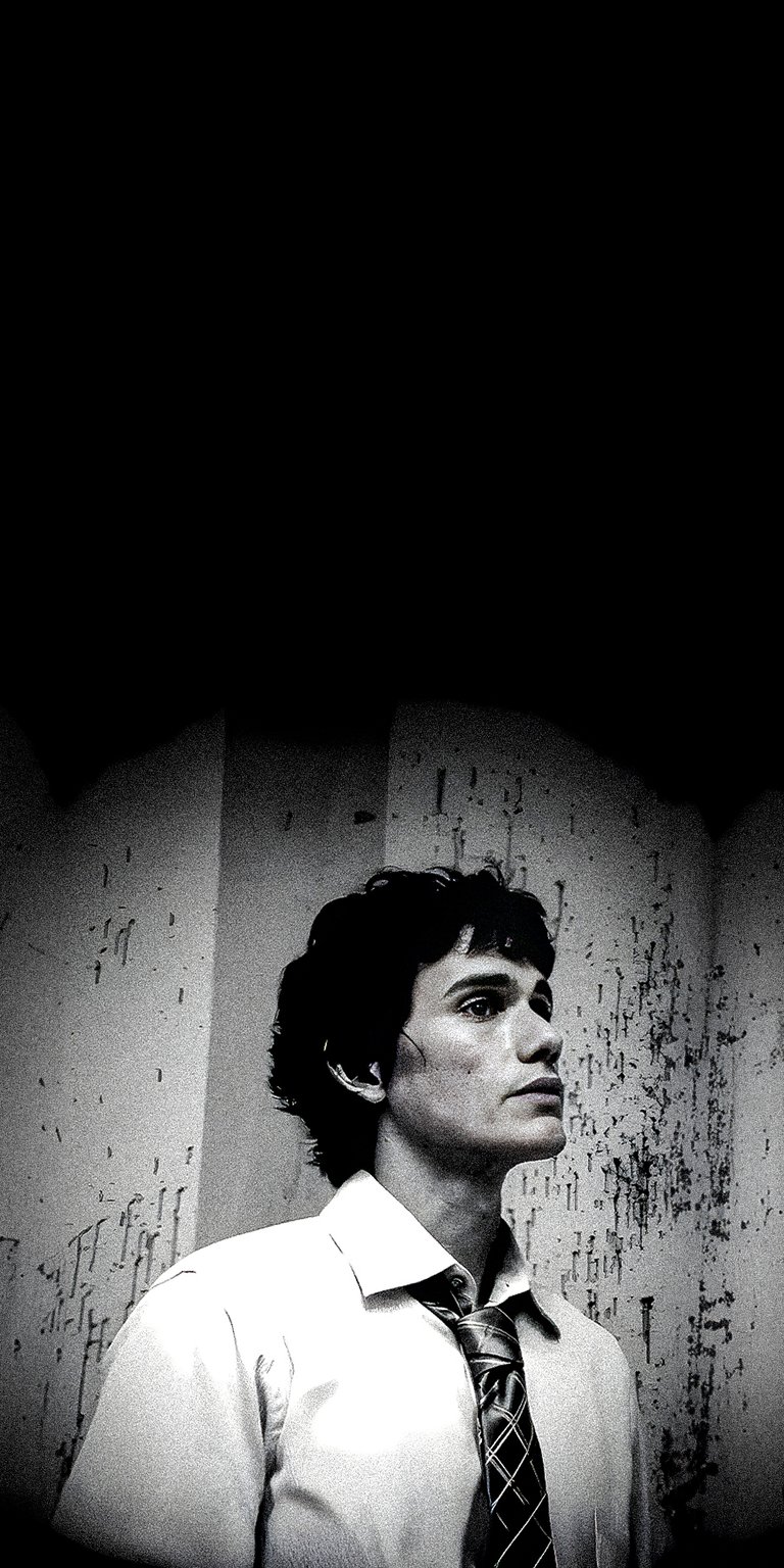 Christian Camargo in black and white photo standing close to old wall wallpapers