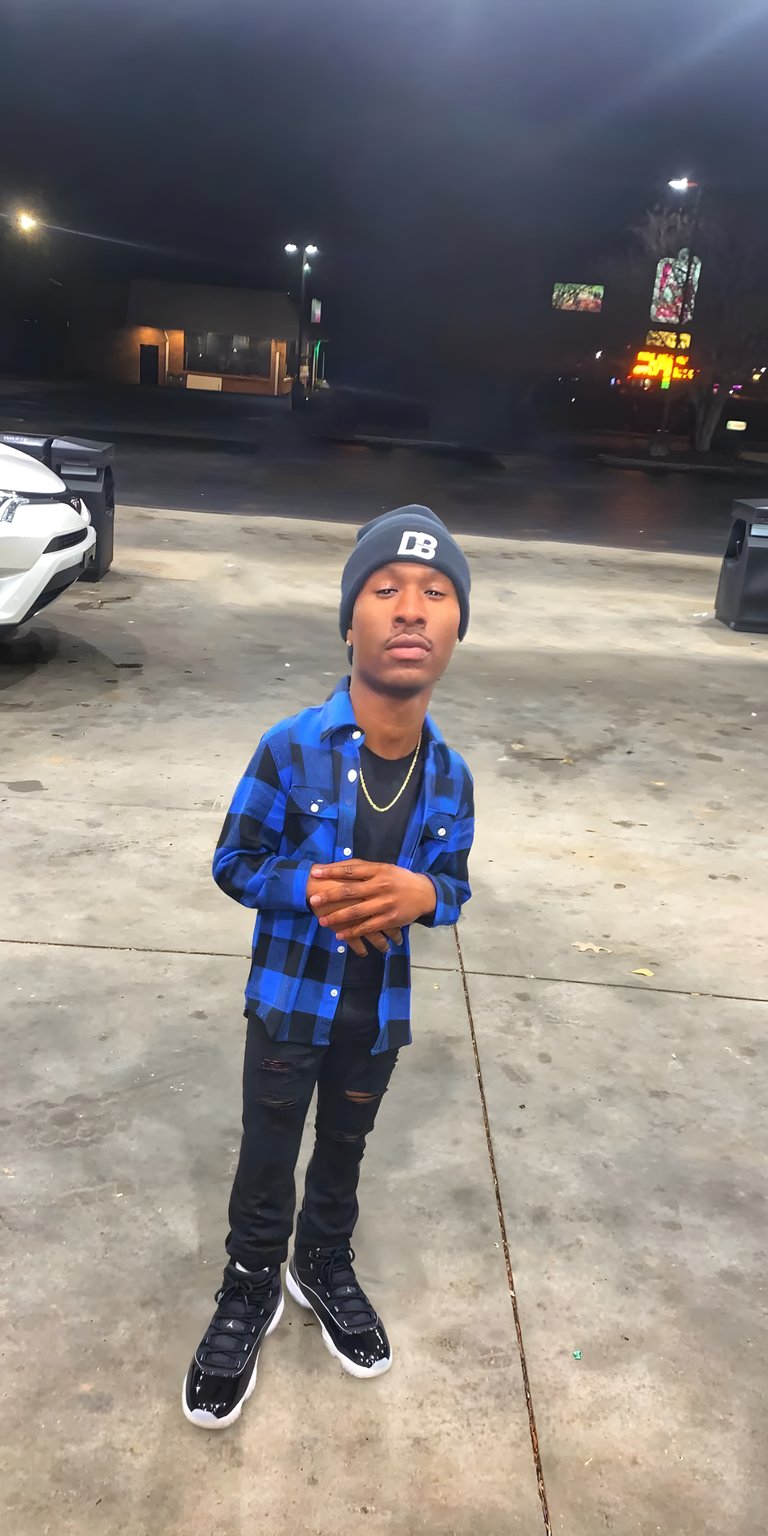 blue man stand boy pose shirt sweatshirt baseball hat shoe parking lot dennis duke