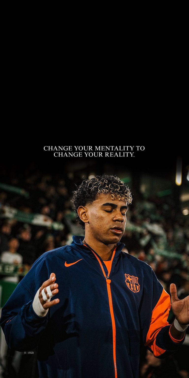 This Lamine Yamal 4K wallpaper features the young football star in a cinematic, high-contrast OLED style perfect for an iPhone lock screen. The deep black background highlights the vibrant orange accents of his jacket and the motivational quote, creating a focused and inspiring mood.