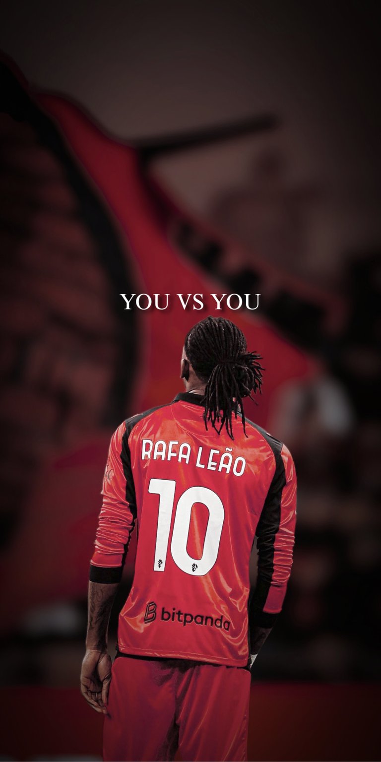 Download a stunning 4K wallpaper of Rafael Leao for your iPhone! This wallpaper showcases Leao with his signature dreadlocks tied back, wearing his red and black jersey with the number 10.