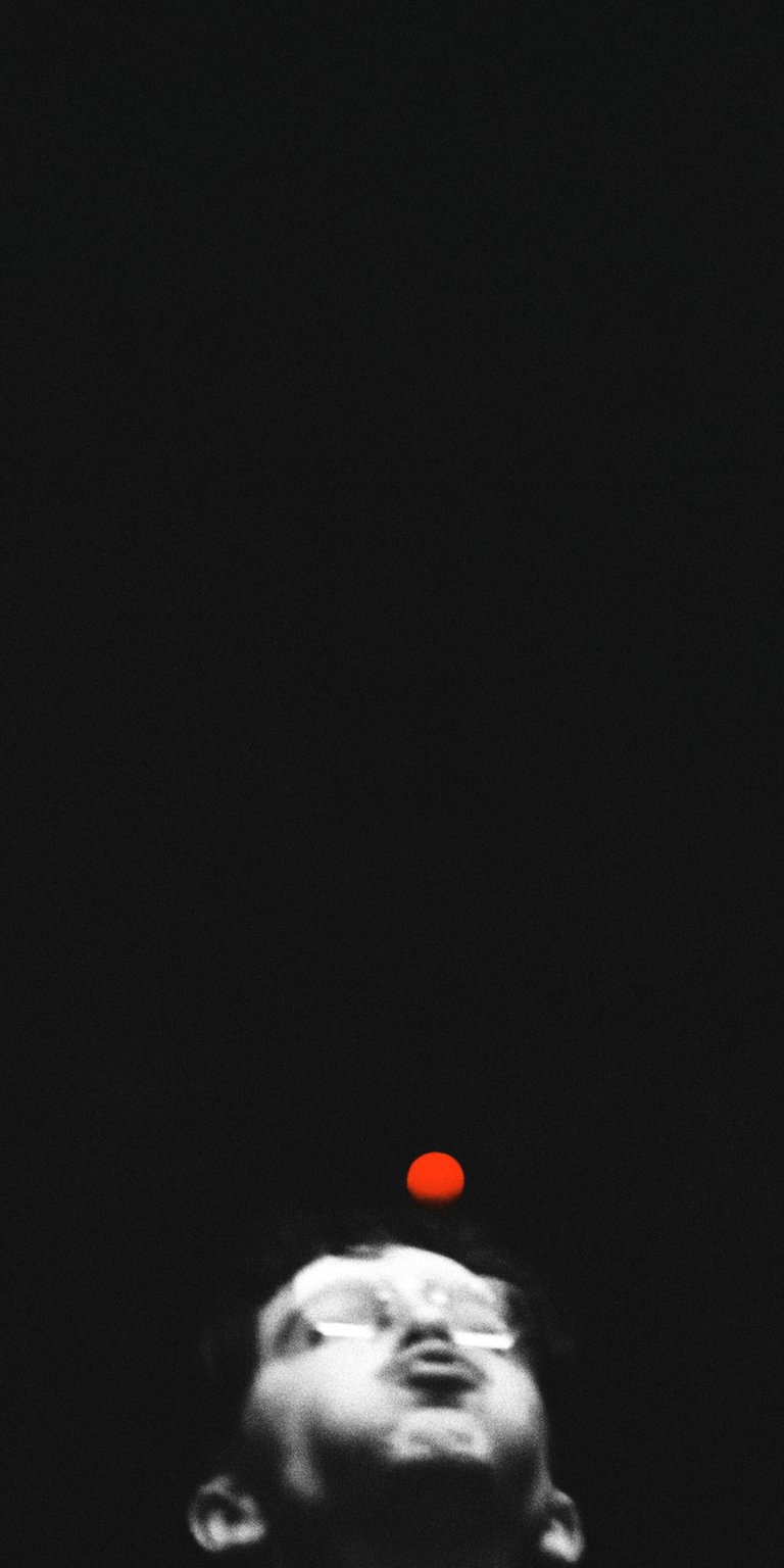 Elevate your iPhone with this captivating wallpaper, showcasing a person gazing up towards a suspended red orb. This 4K wallpaper features a monochromatic color scheme, emphasizing the intense contrast between the subject and the mysterious light.