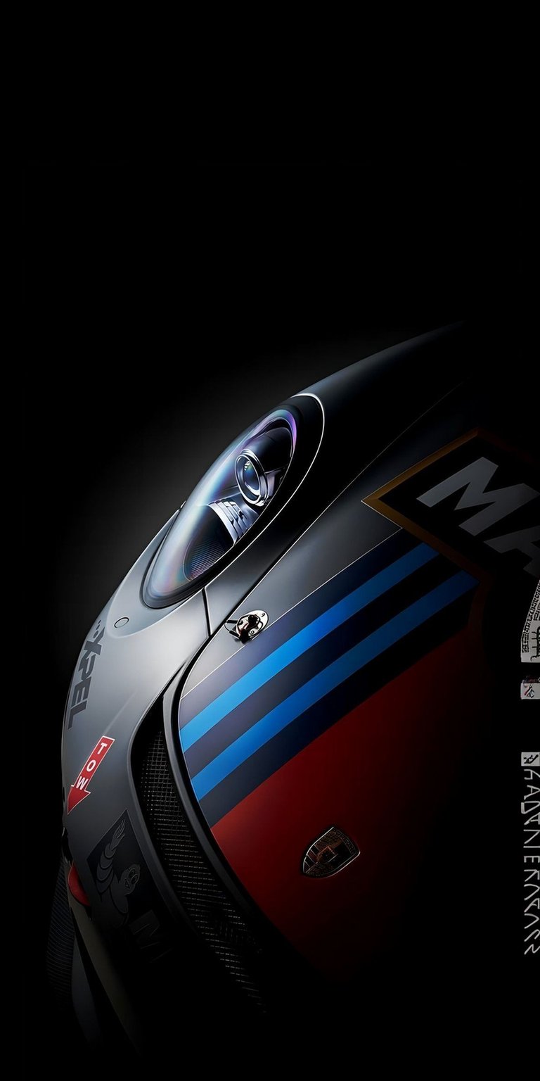 This Porsche 911 GT3 Martini Racing 4K wallpaper features a high-contrast OLED / AMOLED aesthetic perfect for your iPhone. The composition highlights the iconic livery and sleek headlight detail emerging from deep shadows for a dramatic look.