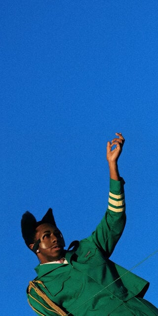 Tyler the Creator performing in Brooklyn wearing green outfit wallpaper