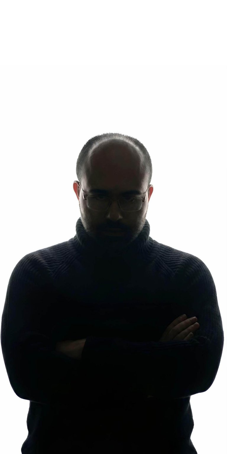 The iconic Danny Slicer silhouette wallpaper featuring the viral TikTok personality in his signature black turtleneck pose. This high-contrast iPhone wallpaper captures the "hard" aesthetic with dramatic rim lighting and deep shadows for a clean, minimalist lock screen.