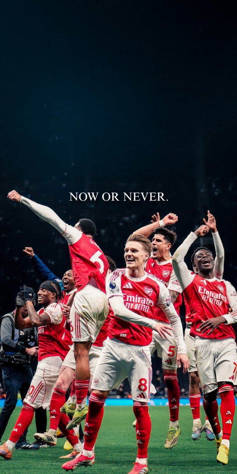 Get this Arsenal players 4K wallpaper for your iPhone, showcasing the team's victorious spirit. The wallpaper highlights the players' red and white kits, the green grass, and the text 'Now or Never'.
