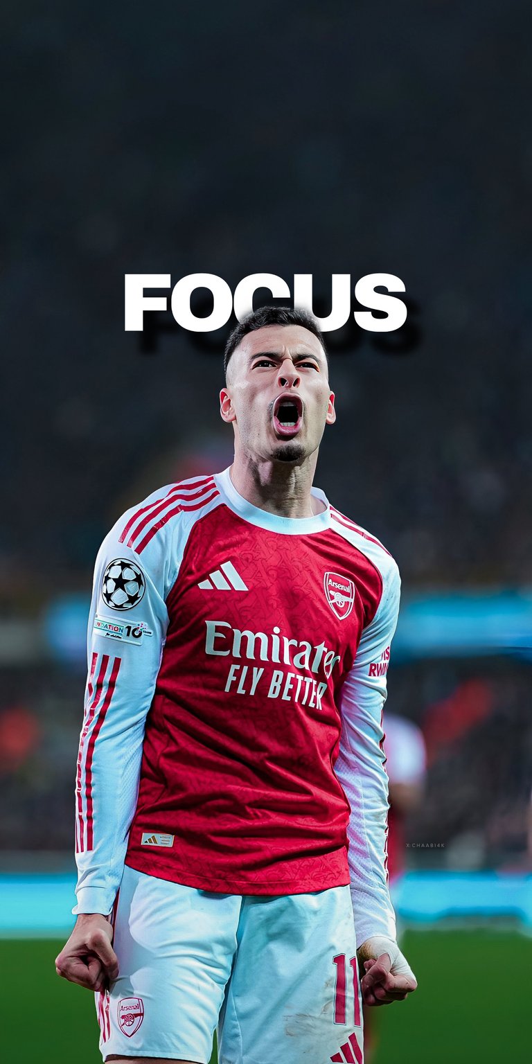 A powerful 4K wallpaper featuring Arsenal's star forward Gabriel Martinelli in intense match action, overlaid with the motivational text "FOCUS." This dynamic shot captures the spirit of the Emirates Stadium and is perfect for fans who want a high-resolution, inspiring image on their device. Elevate your screen with this stunning sports aesthetic!