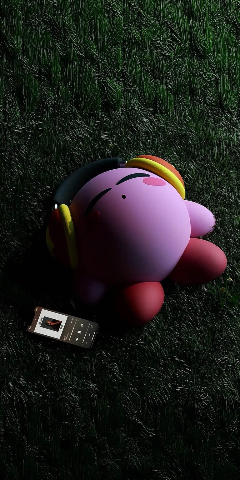 This 4K 3D wallpaper features a high-fidelity render of Kirby relaxing on a lush, textured lawn while listening to music. Perfect for an iPhone lock screen, this aesthetic wallpaper captures a serene, cinematic mood with deep green shadows and soft pink highlights.