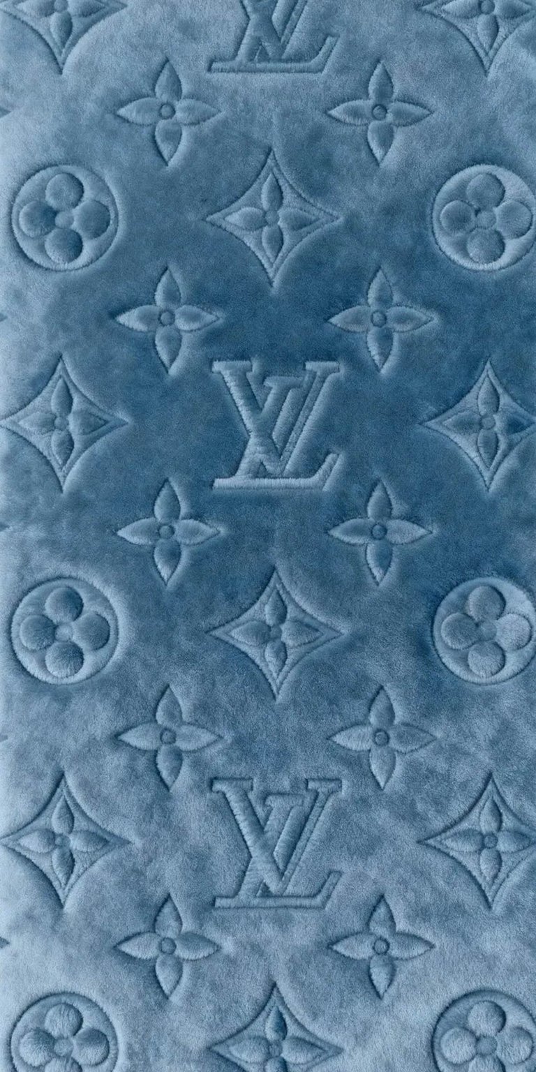 This 4K wallpaper showcases the iconic Louis Vuitton monogram pattern with a sophisticated embossed texture. Optimized for iPhone, the deep blue velvet aesthetic provides a high-end, tactile look that brings a touch of luxury to your mobile background.
