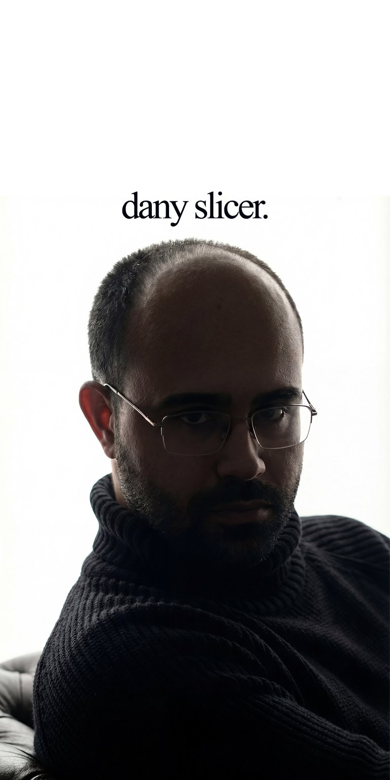 Danny Slicer Portrait Static wallpaper featuring a minimalist composition with a clean white background and soft shadow lighting. This minimalist wallpaper for iPhone highlights a close-up portrait in a dark knit sweater with subtle contrast and name text above, creating a sharp and modern lock screen or home screen look.
