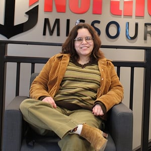 Student sitting in the lounge of the Student Center on the Trenton campus