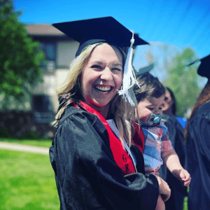 Graduate with a toddler at graduation