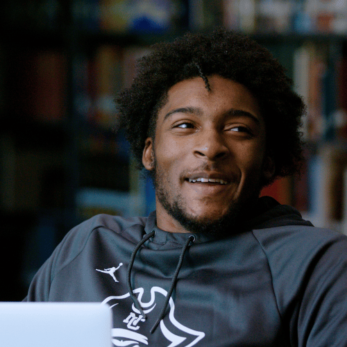 Student wearing a black Pirate hoodie