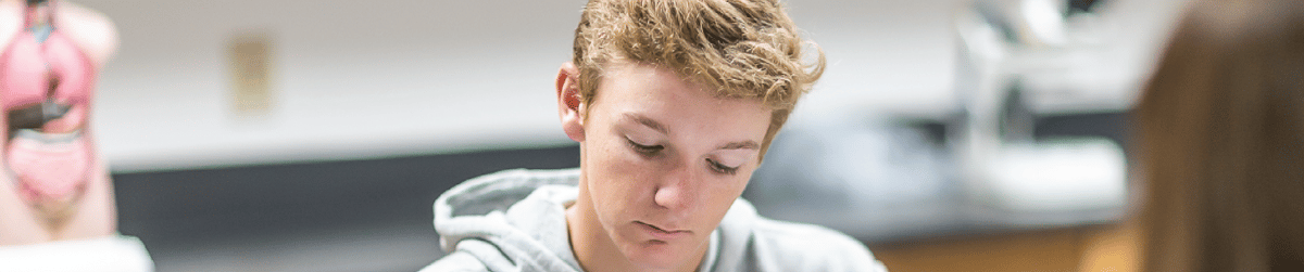 Student wearing a gray hoodie in the lab