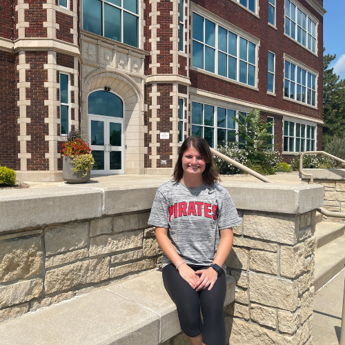 Student sitting by Geyer Hall