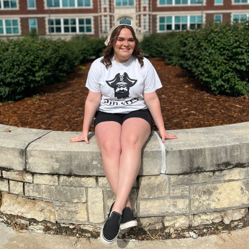 Student sitting on the ledge