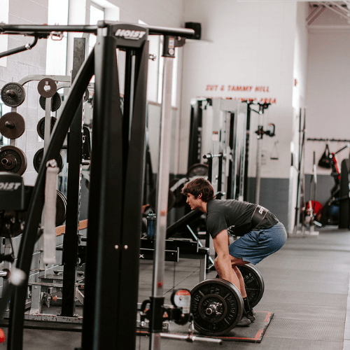 Student using gym equipment