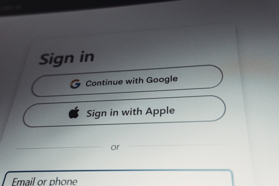 A sign-in screen photographed at an angle, showing sign-in buttons above an email field.