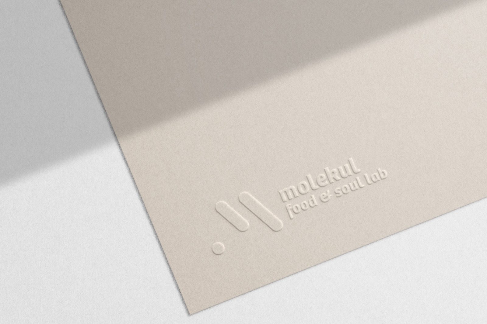 Embossed marks on cards and paper — the logo you feel before you read it.