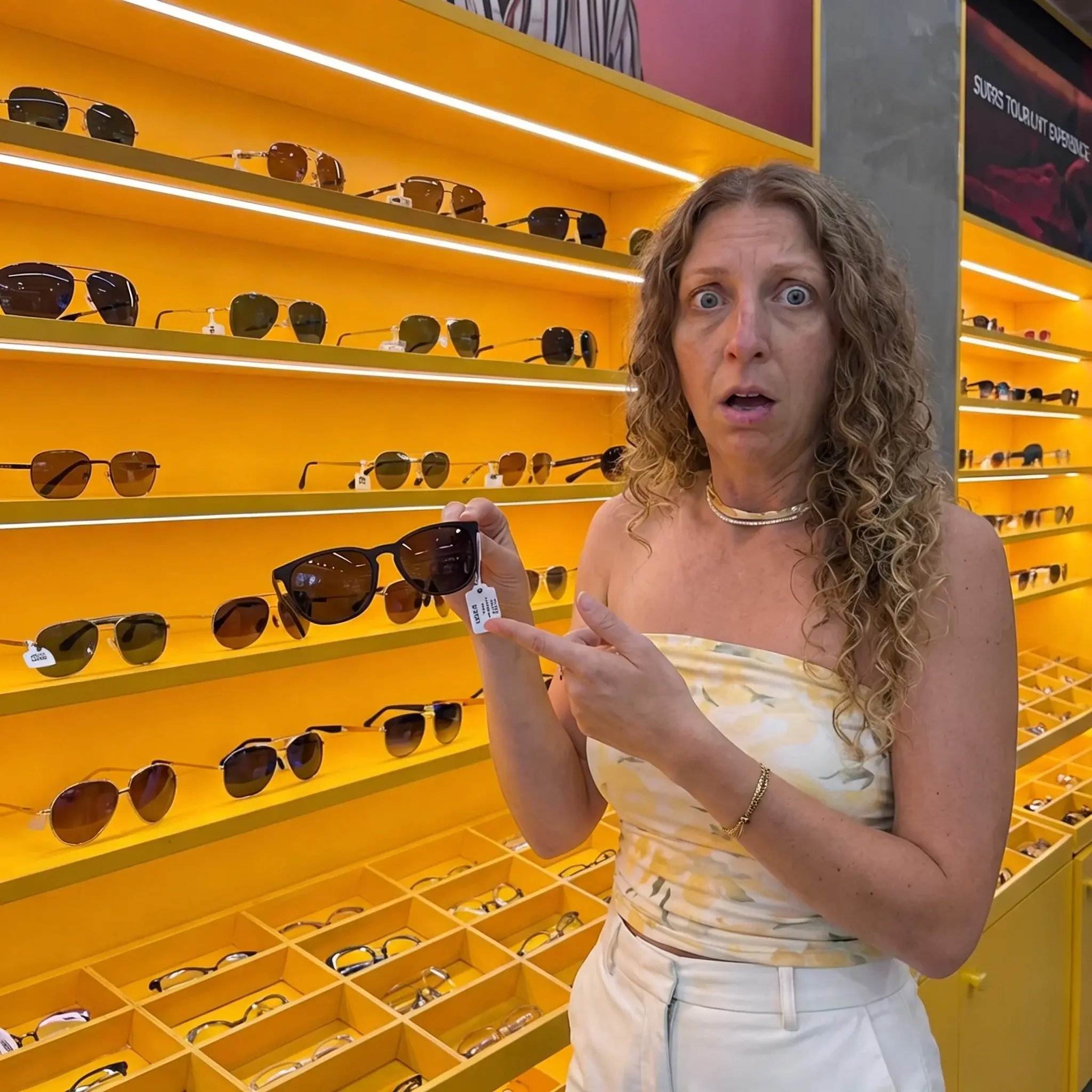 Woman shocked at the price tag on prescription sunglasses at an optical store