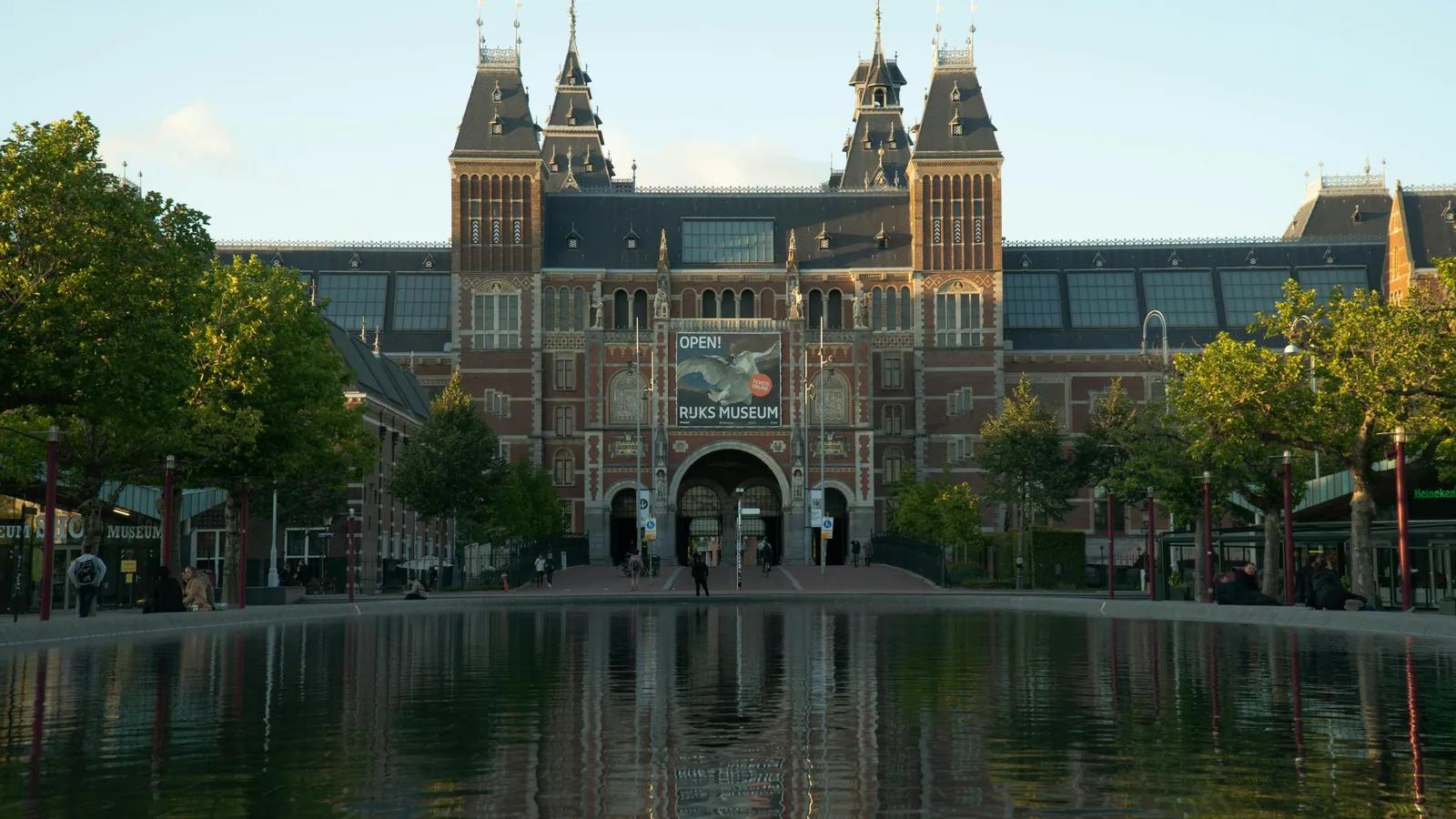 Rijksmuseum in Amsterdam, das sich im Wasserbecken am Museumplein spiegelt