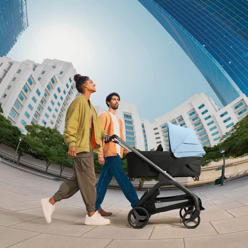 ein Pärchen geht mit dem Buggy Dragonfly von Bugaboo in der Stadt spazieren