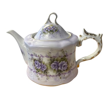 Purple floral porcelain teapot music box, 6.25" h, 9.75" w, 5.5 " d