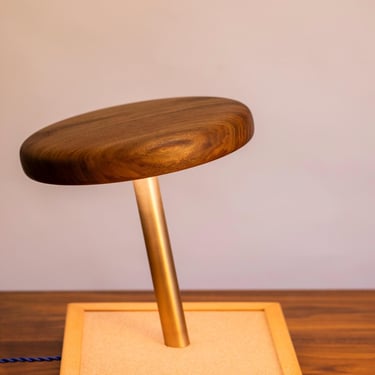 A larger-than-life Walnut thumbtack that lights up your space — literally. 