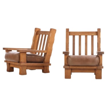A Pair of French Heavy Oak Brutalist style Open Arm Chairs, C. 1960.