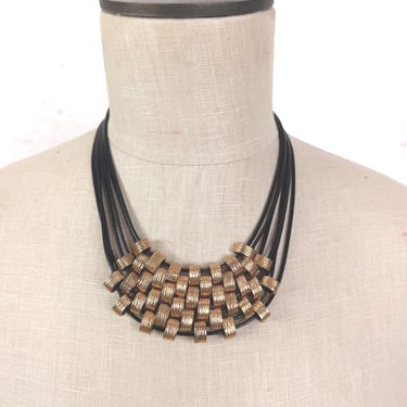 Multi-Strand Black Cord Necklace with Gold Tone Woven Pendant 