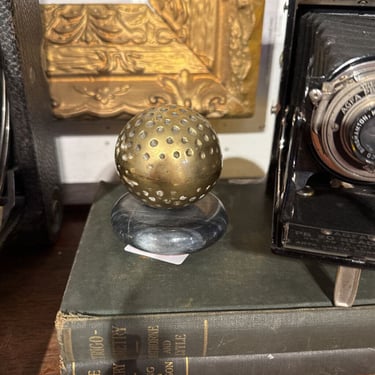 Brass golf ball. Marble base