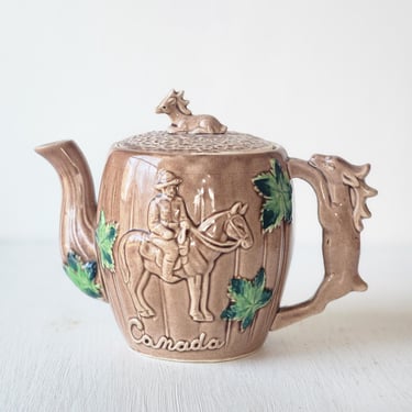 Canada souvenir teapot vintage ceramic with RCMP and maple leaves elk handle 
