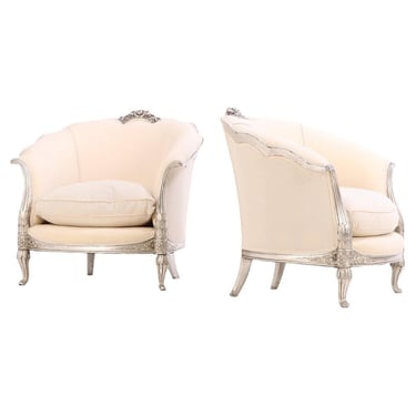 A Pair of French Louis XV style silver leaf lounge chairs, C. 1930.