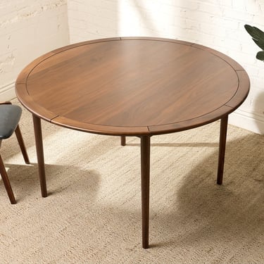 Modern Round Walnut-Tone Dining Table with Tapered Legs