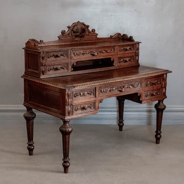 1870's French Louis XIII Ornate Hand Carved Oak Writing Desk w/ Extensive Floral and Foliate Detailing Throughout & a Fox Head Accent