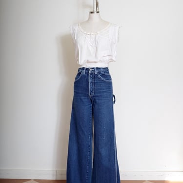 vintage 80s wide leg jeans by Lawman / dark wash denim white stitching / carpenter jeans w/ raw hem / 27