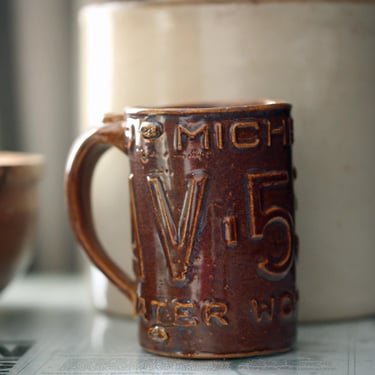 Vintage Handmade Michigan License Plate Pottery Mug – AV-5322 – 5” Tall | Rustic Stoneware | One-of-a-Kind Artisan Piece 