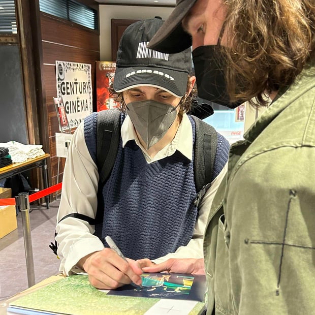 Photo of Porter signing my copy of Shelter