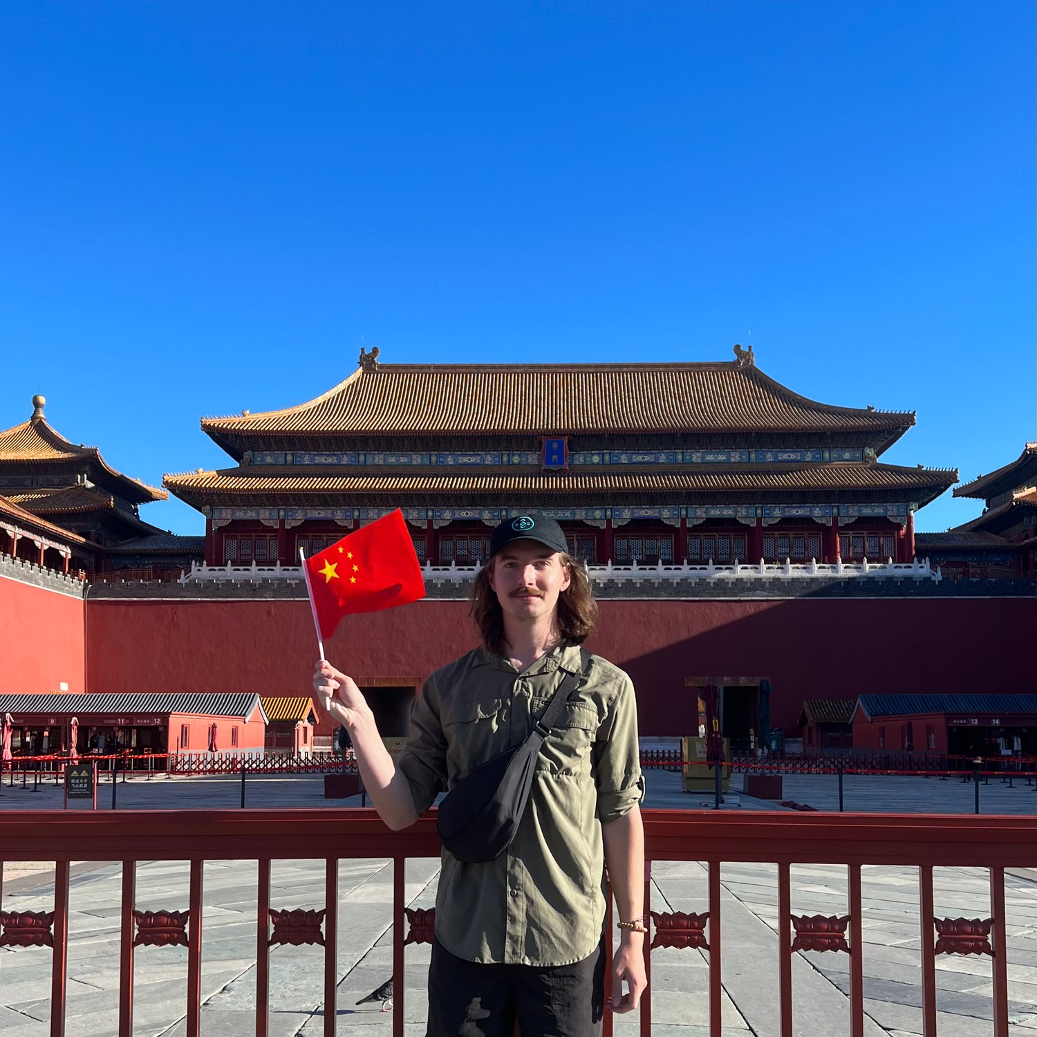 Photo of Waving a 🇨🇳 flag in front of the Forbidden City