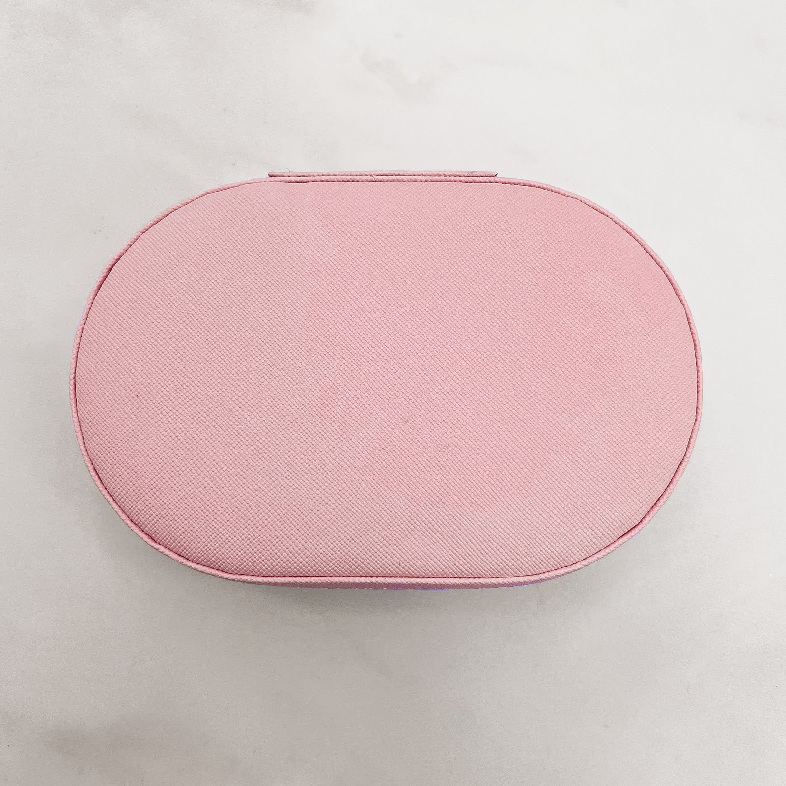 Porta-joias oval rosa 14x9x4cm zíper dourado