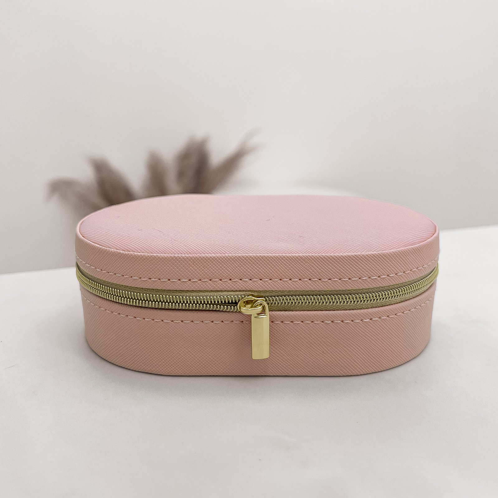 Porta-joias oval rosa 14x9x4cm zíper dourado