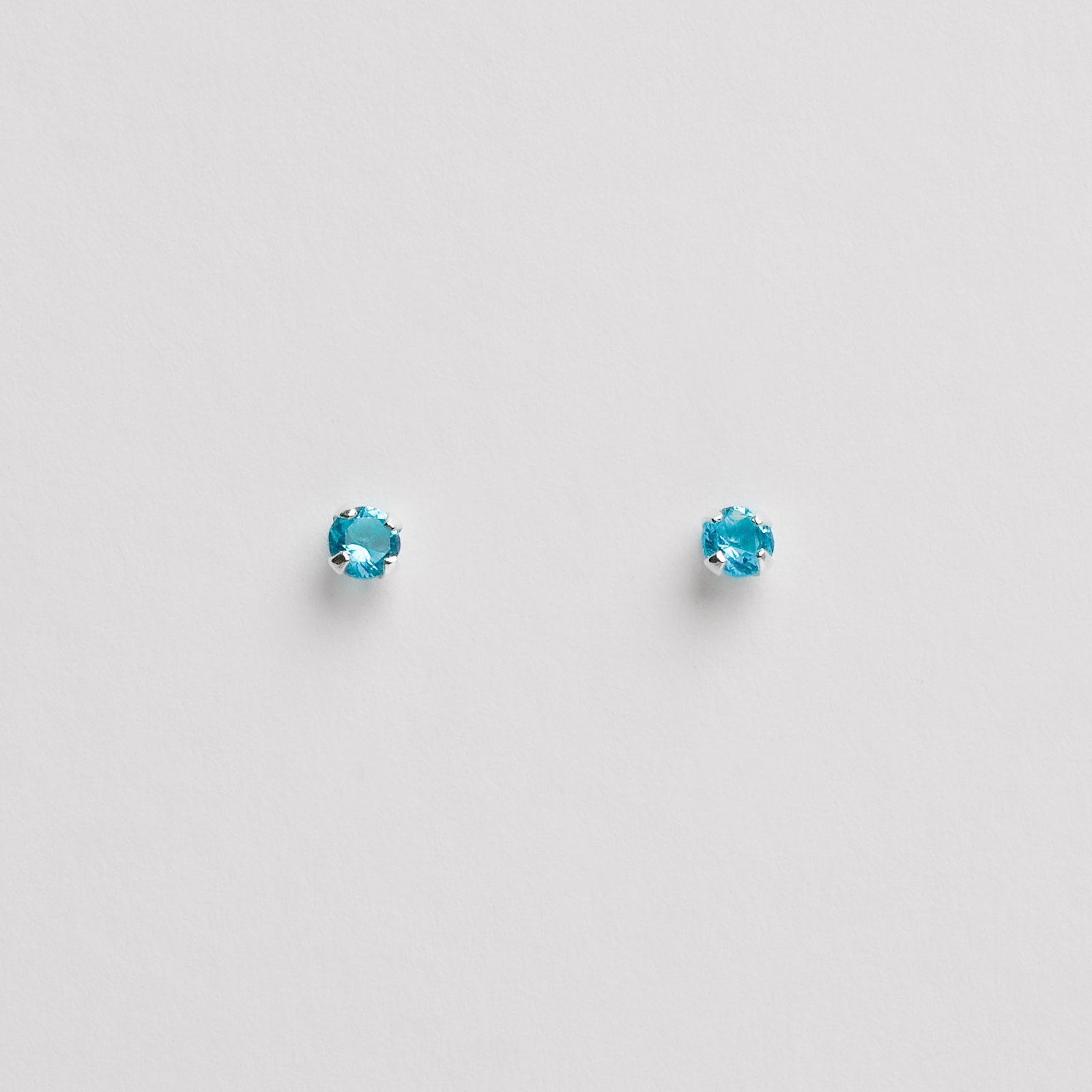 Brinco zircônia redonda azul 3mm garra