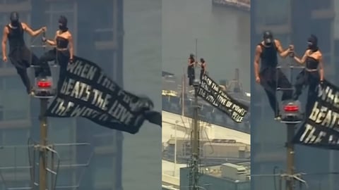 Mensaje de Paz y Amor en el Empire State: Dos Encapuchados Despliegan Bandera