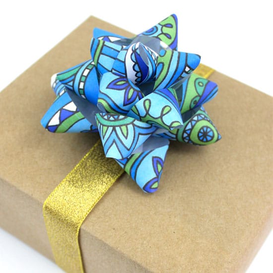 Use a coloring page to make a gift bow | Click to see all 29 creative ways to repurpose your coloring pages | #coloringpage #crafts www.sarahrenaeclark.com