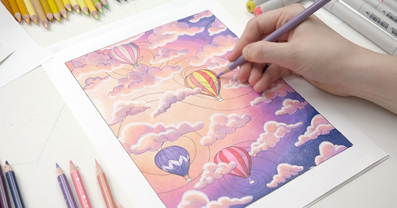 Adult coloring page with Sarah's hand Coloring in the hot air balloons