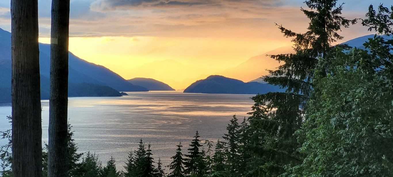 Aerial view of the Sunshine Coast shoreline with mountains and turquoise water