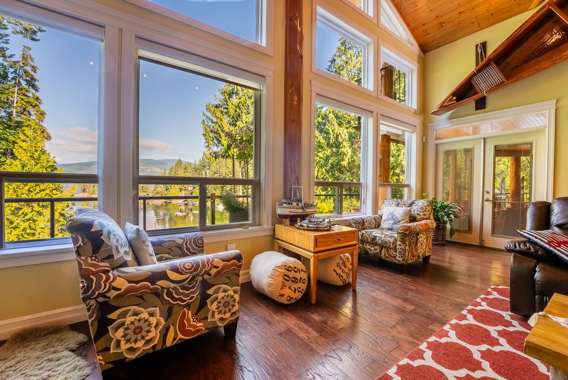 Sitting area with patterned armchairs and floor-to-ceiling windows