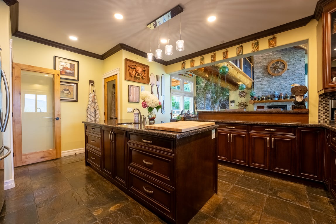 Kitchen with a large granite island and pendant lighting