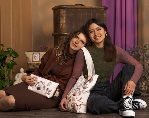 Two models presenting Poopyliine Webshop Tote and Vanity Bag