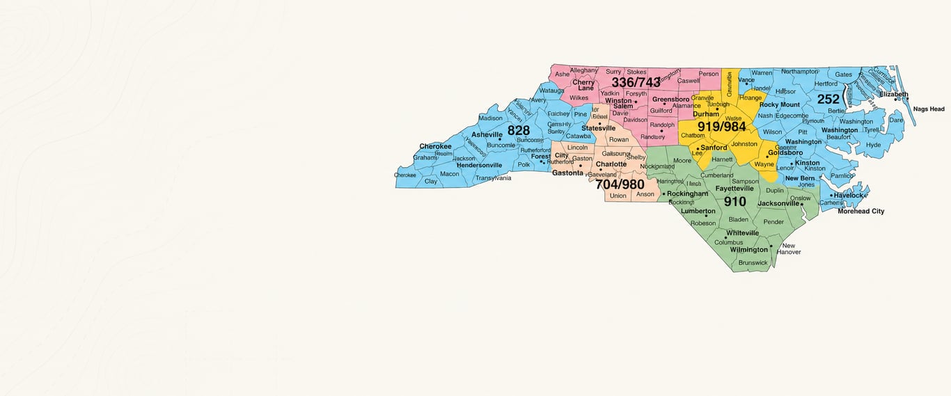 Map of North Carolina area codes showing 336 and 743 in the Piedmont Triad, 704 and 980 around Charlotte, 919 and 984 in the Triangle, 910 in the southeast, 252 in the east, and 828 in the mountains