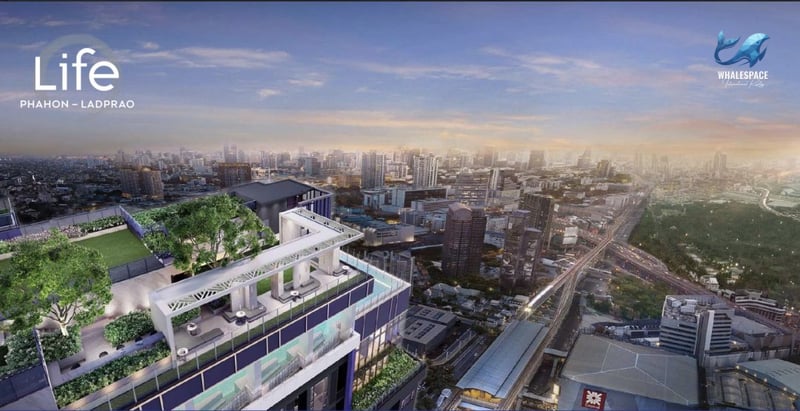 Aerial view of the building's rooftop garden and city skyline at dusk
